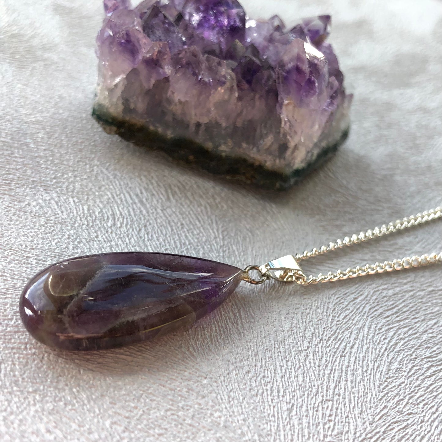 Tiny amethyst worry stone pendant