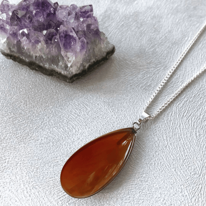 Tiny carnelian worry stone pendant