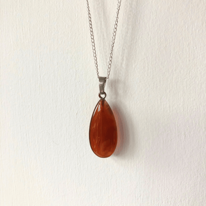 Tiny carnelian worry stone pendant