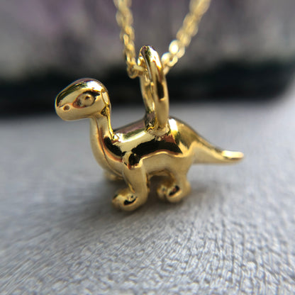Tiny gold Diplodocus dinosaur pendant