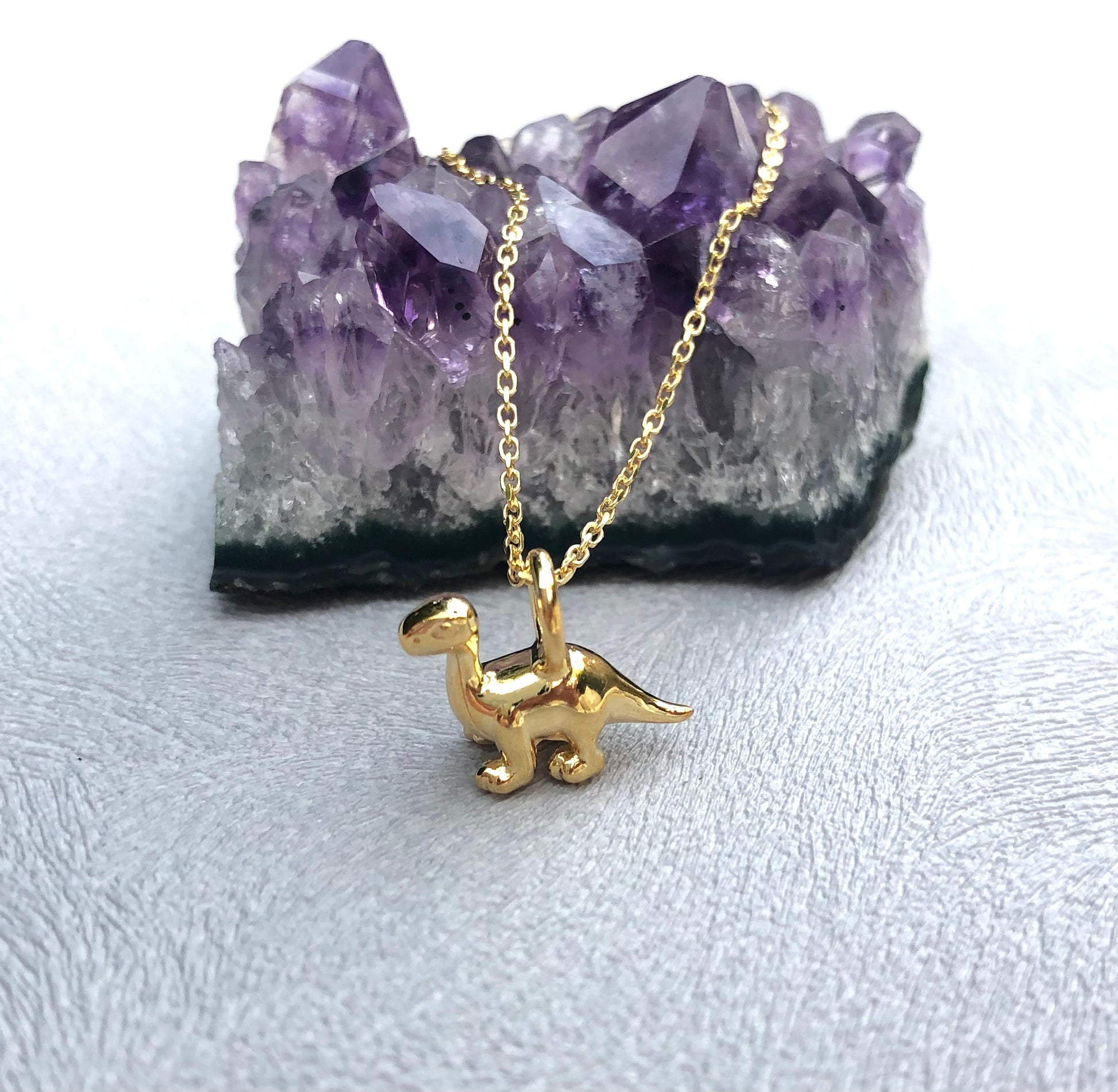 tiny gold dipoducus pendant